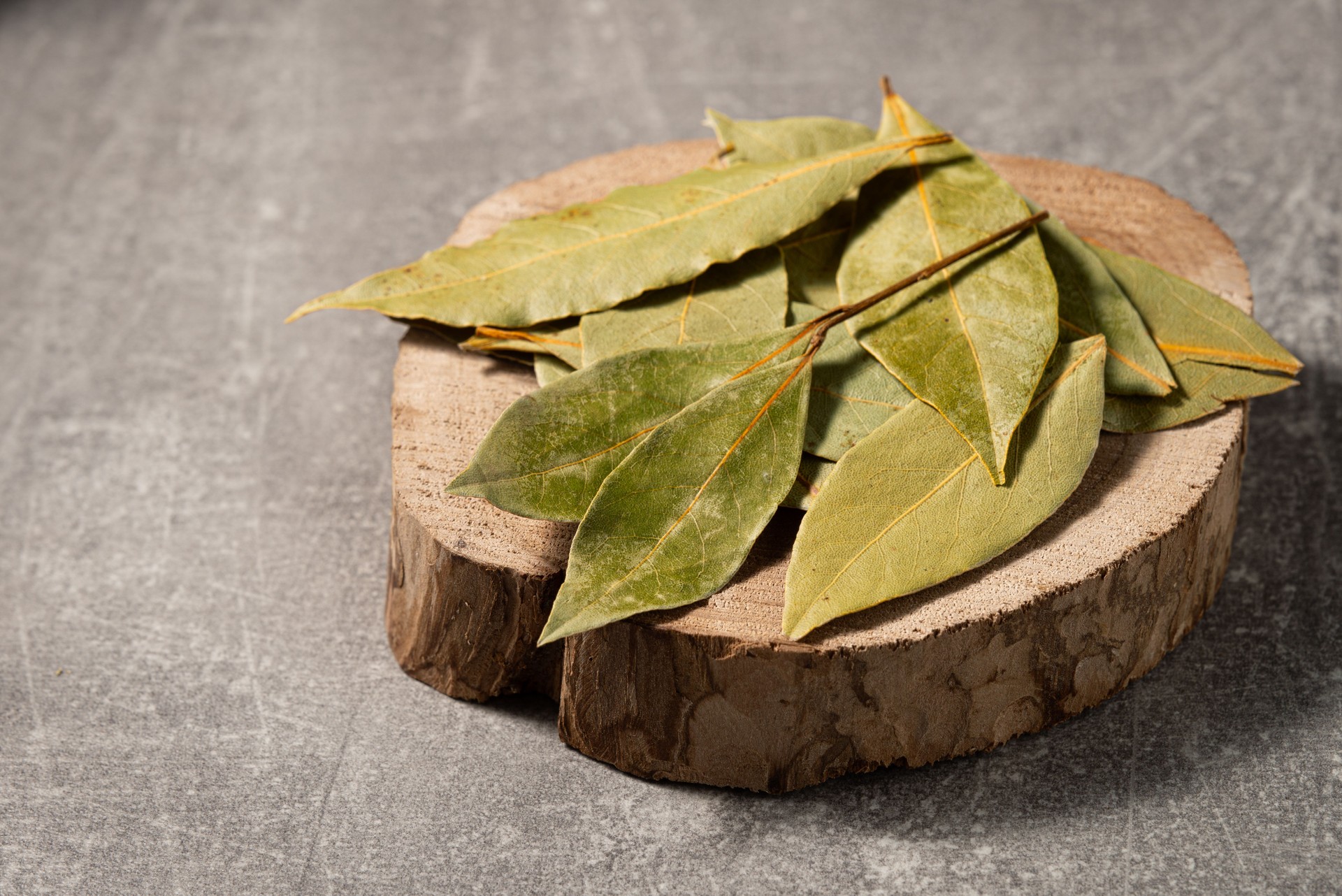 Dried bay leaves on a wooden board. Front view.